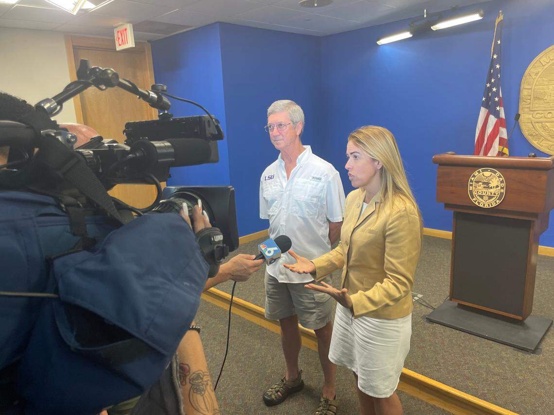 Don Harris, a veterinarian, and Raquel Regalado, a Miami-Dade County Commissioner, talk to the media about a new county-approved plan by Pinecrest to hire Harris to perform vasectomies on wild peacocks.