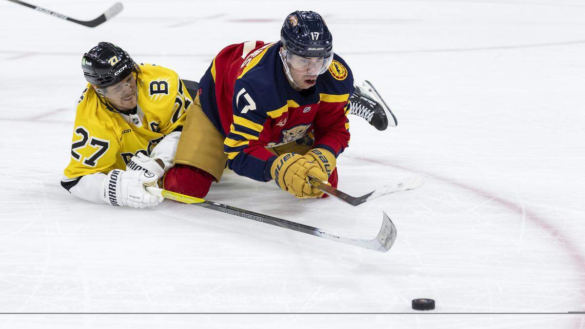 Florida Panthers center Evan Rodrigues (17) and Boston Bruins defenseman Hampus Lindholm (27) compete for the puck in the second period of their NHL game at the Amerant Bank Arena on Wednesday, Feb. 4, 2026, in Sunrise, Fla.