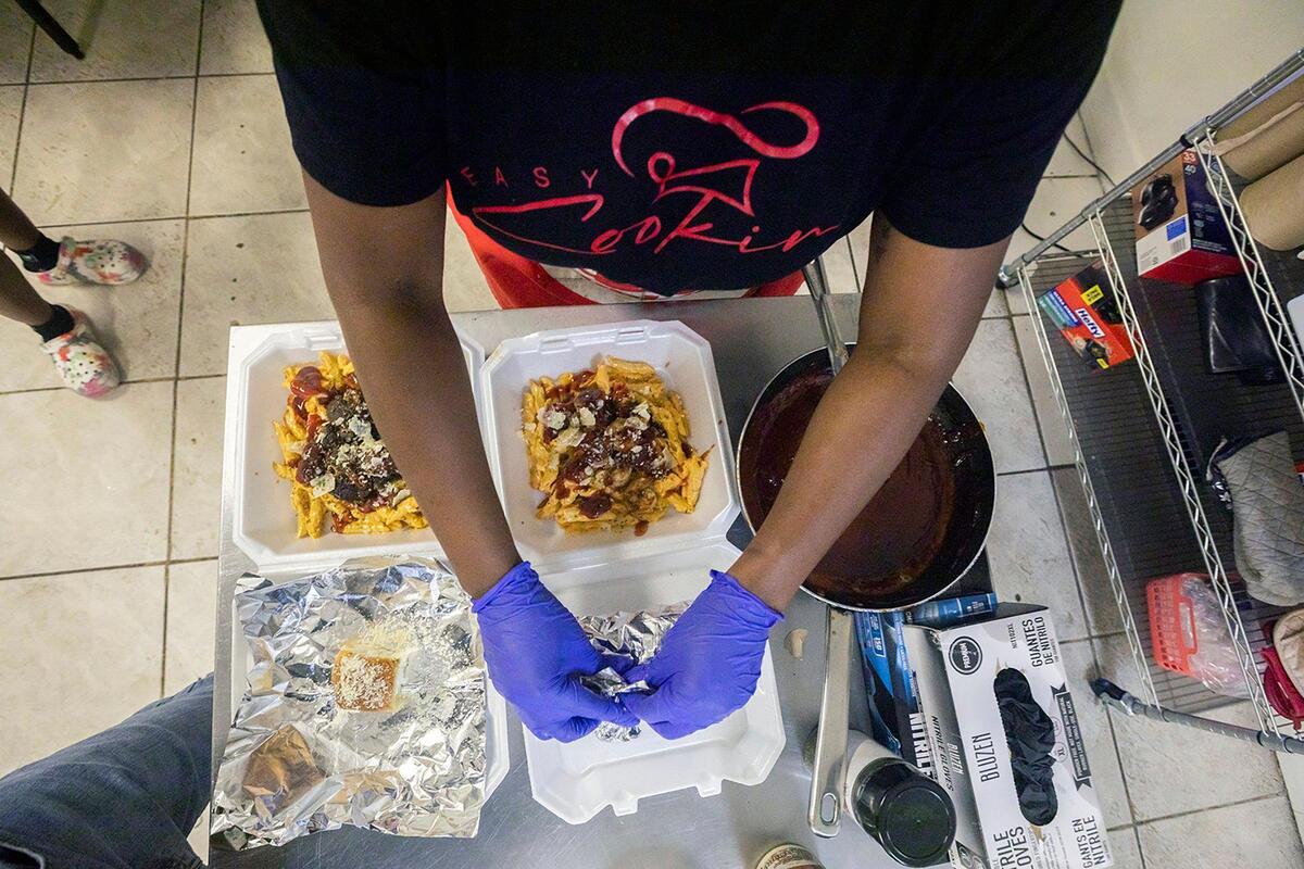 Chef Syerra Donaldson plates meals during an event in Miami Gardens on Saturday, May 24, 2025.