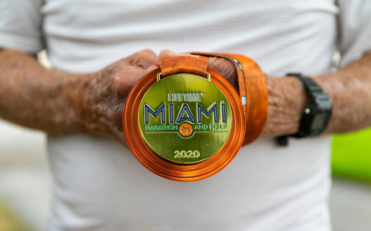 Lewis Ress, 91, holds his Miami Marathon medal at the Don Soffer Exercise Trail in Aventura, Florida on Saturday, January 22, 2022. Ress, a former trial lawyer who still works and is involved in the South Florida community, will compete in the half marathon portion of the Miami Marathon on February 6, 2022.