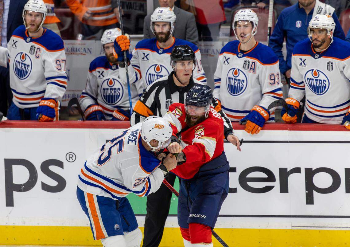 NHL referee Francis Charron (6) looks as Edmonton Oilers defenseman Darnell Nurse (25) and Florida Panthers left wing Jonah Gadjovich (12) fight during the third period of Game 3 in the Stanley Cup Final at Amerant Bank Arena on Monday, June 9, 2025, in Sunrise, Fla.