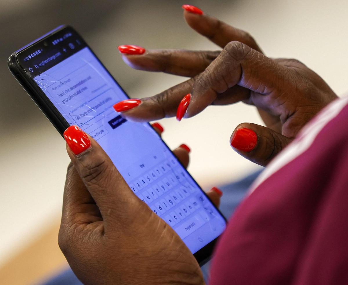 Attendees use their phones to engage in the “pink” break-out session as Broward County Public Schools held the first of three town halls to discuss with the community the possibility of closing schools in 2025 due to under-enrollment at Fort Lauderdale High School on Thursday, February 8th, 2024.