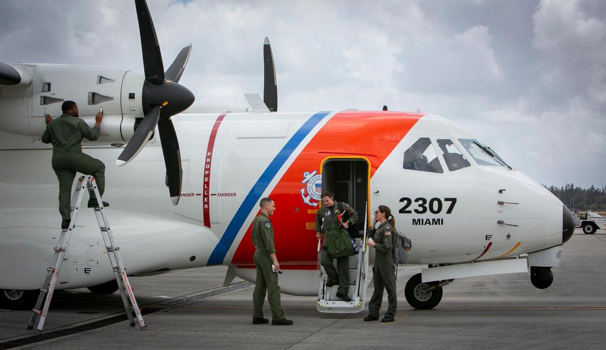 The crew of a U.S. Coast Guard HC-144 Ocean Sentry airplane as they deplane upon arrival in Opa-locka after a reconnaissance flight over the Florida Straits and the Bahamas on Friday, April 22, 2022.