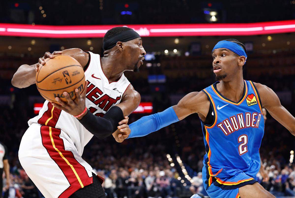 Miami Heat center Bam Adebayo (13) is defended by Oklahoma City Thunder guard Shai Gilgeous-Alexander (2) on a play during the second quarter at Paycom Center.