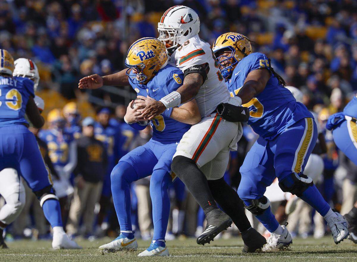 Miami Hurricanes defensive lineman Ahmad Moten (99) sacks Pittsburgh Panthers quarterback Mason Heintschel (6) on the opening play of the game in the first half during their NCAA football game at Acrisure Stadium in Pittsburgh, PA, on Saturday, November 29, 2025.
