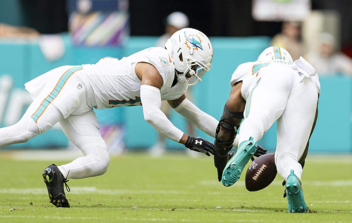 Miami Dolphins linebacker Jordyn Brooks (20) recovers a fumble against the Los Angeles Chargers in the first half of their NFL game at Hard Rock Stadium on Sunday, Oct. 12, 2025, in Miami Gardens, Fla.
