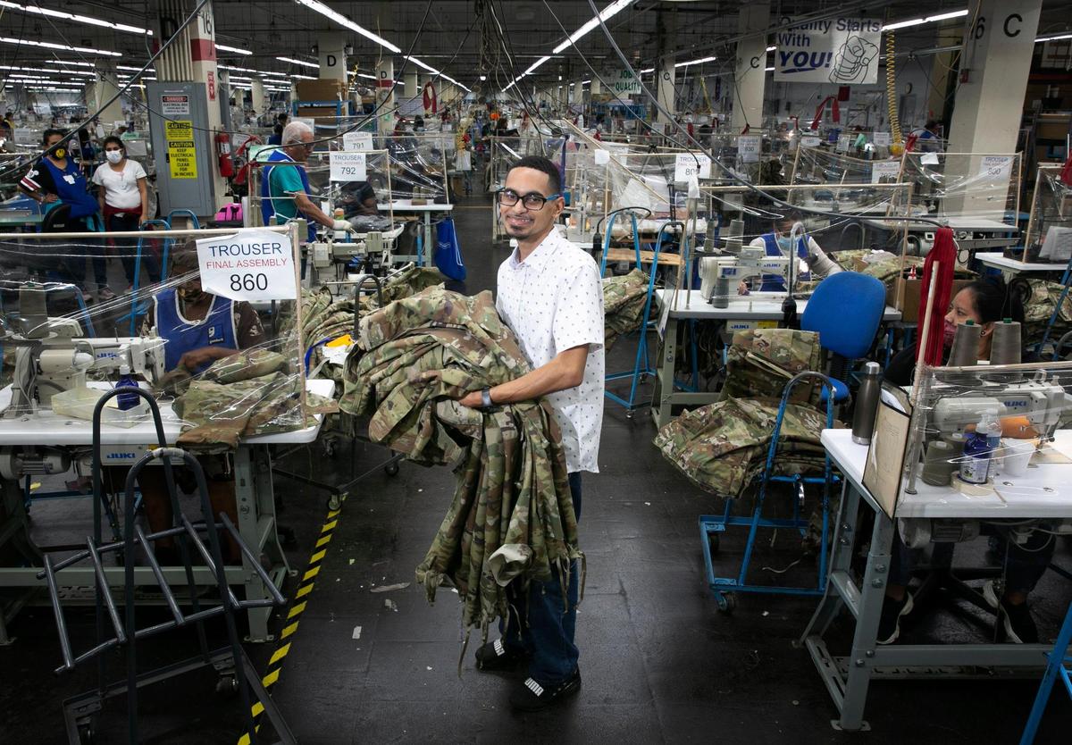 Andre Amador, 29, has worked at Goodwill South Florida for ten years. He was promoted recently to work on tying the hems of the Army uniforms that Goodwill employees make in the apparel manufacturing division of the Miami shop.