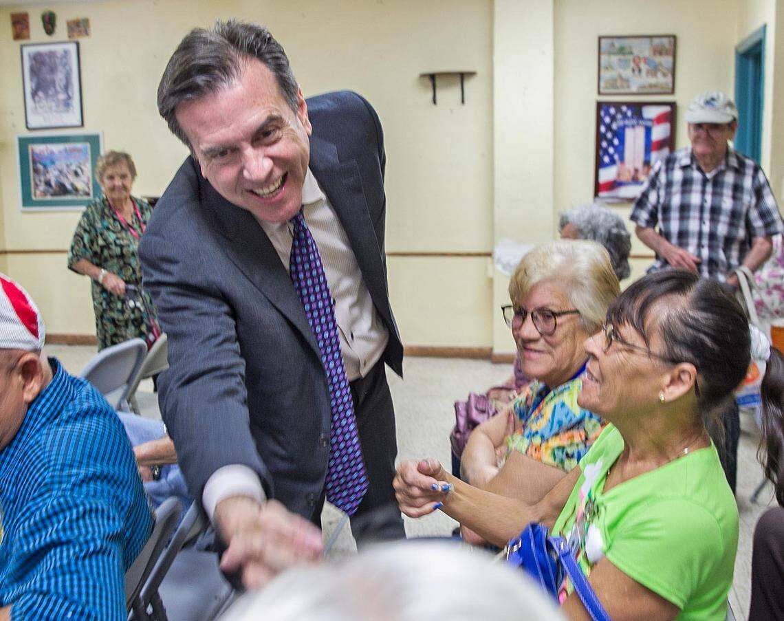 Miami-Dade Commission candidate Alex Diaz de la Portilla visits with senior citizens from the Little Havana Activities and Nutrition Center de la Portilla shakes hands as he campaigns for their vote on Friday, May 11, 2018