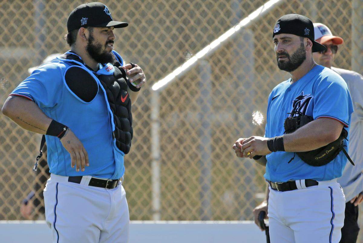 Miami Marlins catcher Jorge Alfaro (38) talks with catcher Francisco Cervelli (29) during the first full-squad spring training workout at Roger Dean Stadium on Monday, February 17, 2020 in Jupiter, FL.