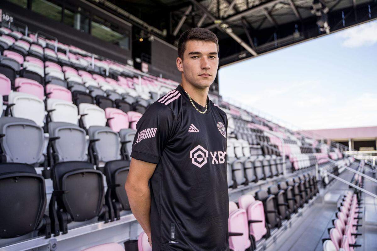 Inter Miami forward Robbie Robinson shows off the new jersey sleeve sponsor, XMANNA, a software company focused on gaming, sporty loyalty and engagement.