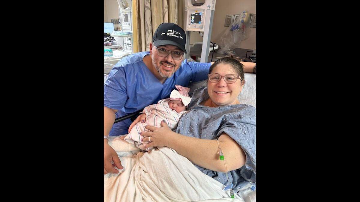 Sienna Muriel, a baby girl born Jan. 1, 2026, is held by her parents, Kimberly and Nickolas Muriel, at South Miami Hospital.