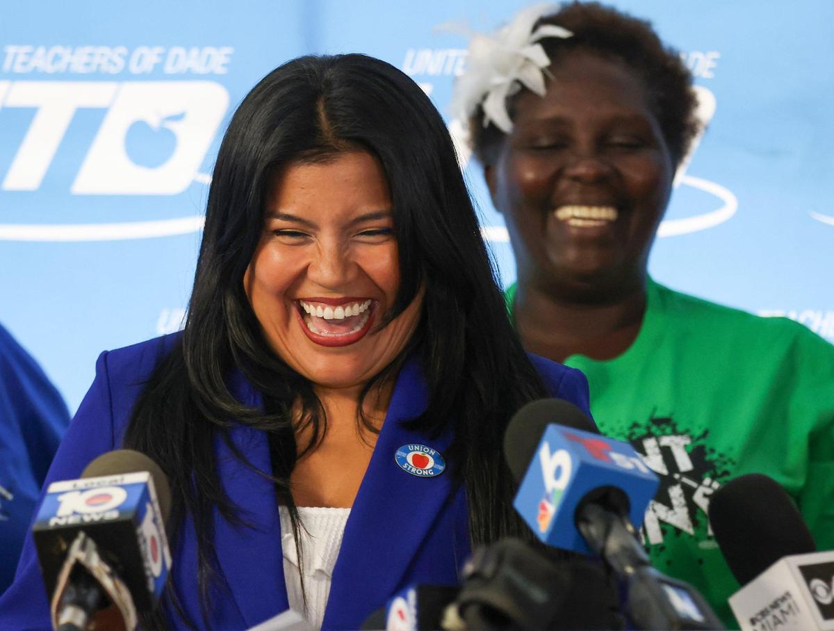 United Teachers of Dade (UTD) President Karla Hernández-Mats, left, smiles after announcing the successful conclusion of negotiations, which resulted in 7 to 10 percent pay increases for teachers in the coming school year, at the UTD office on Thursday, July 27, 2023 in Miami, Florida.