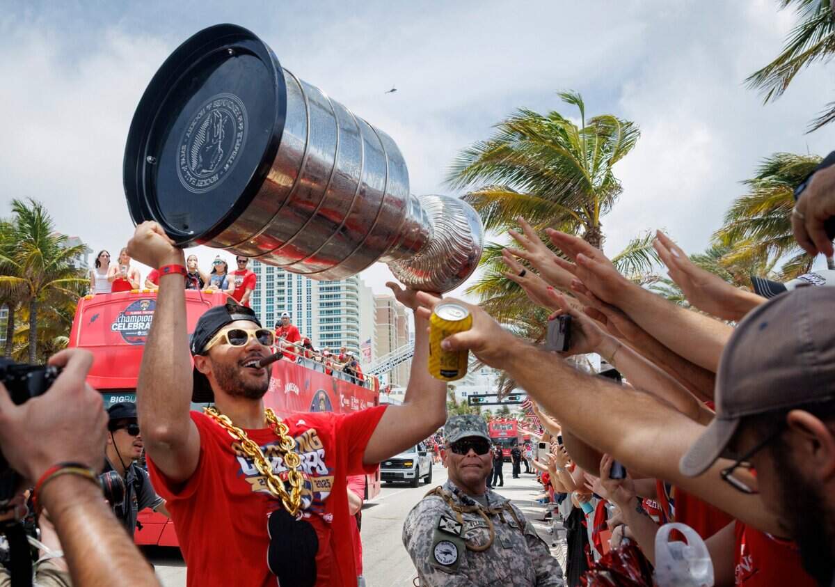 Florida Panthers defenseman Seth Jones (3) lifts the cup up for fans during the Florida Panthers Stanley Cup Championship victory parade on Sunday, June 22, 2025 down Las Olas in Fort Lauderdale, Fla.