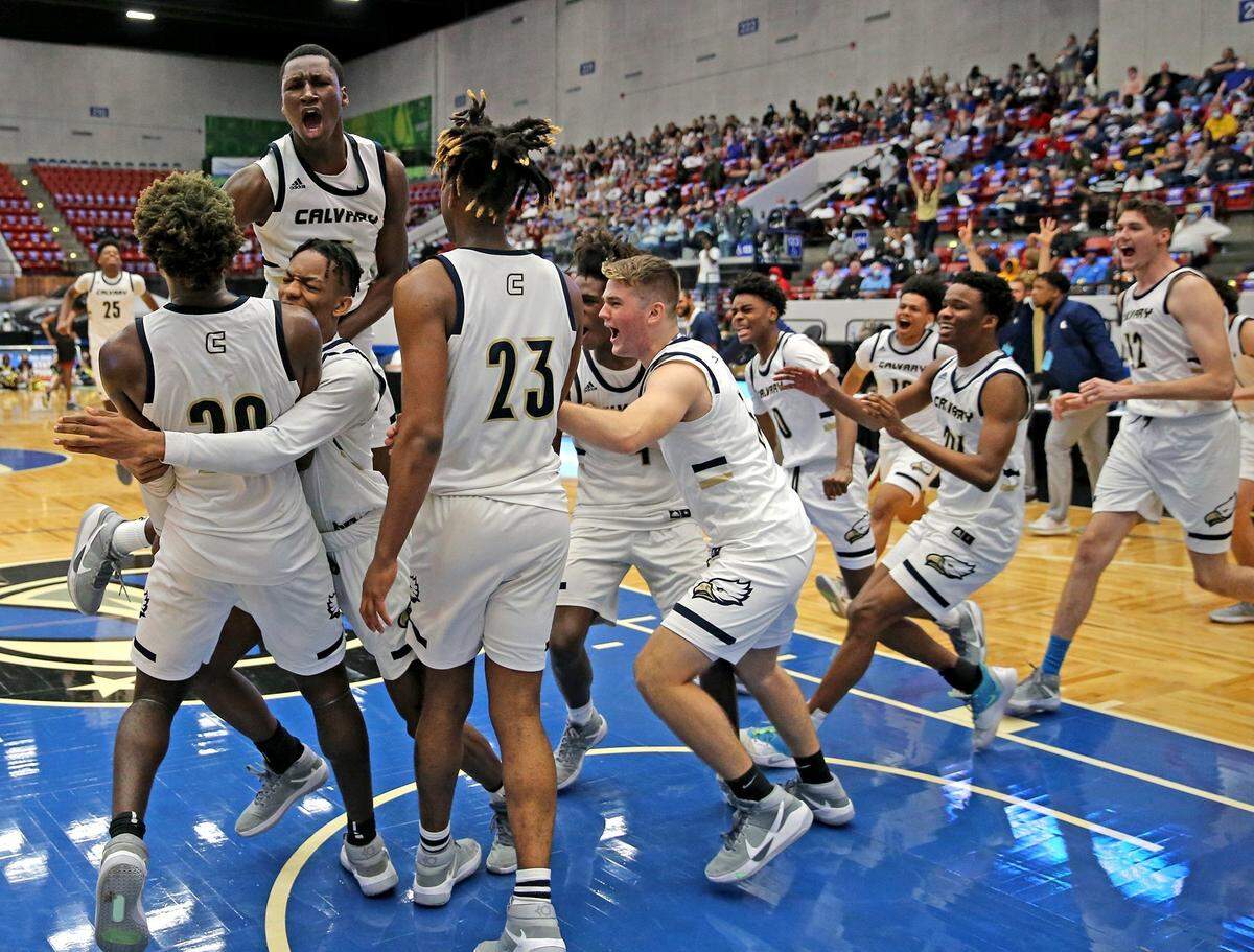 Calvary Christian players celebrate as they defeat Bishop McLaughlin in the FHSAA 3A Boys’ Basketball finals in Lakeland, Florida, Friday, March 5, 2021.