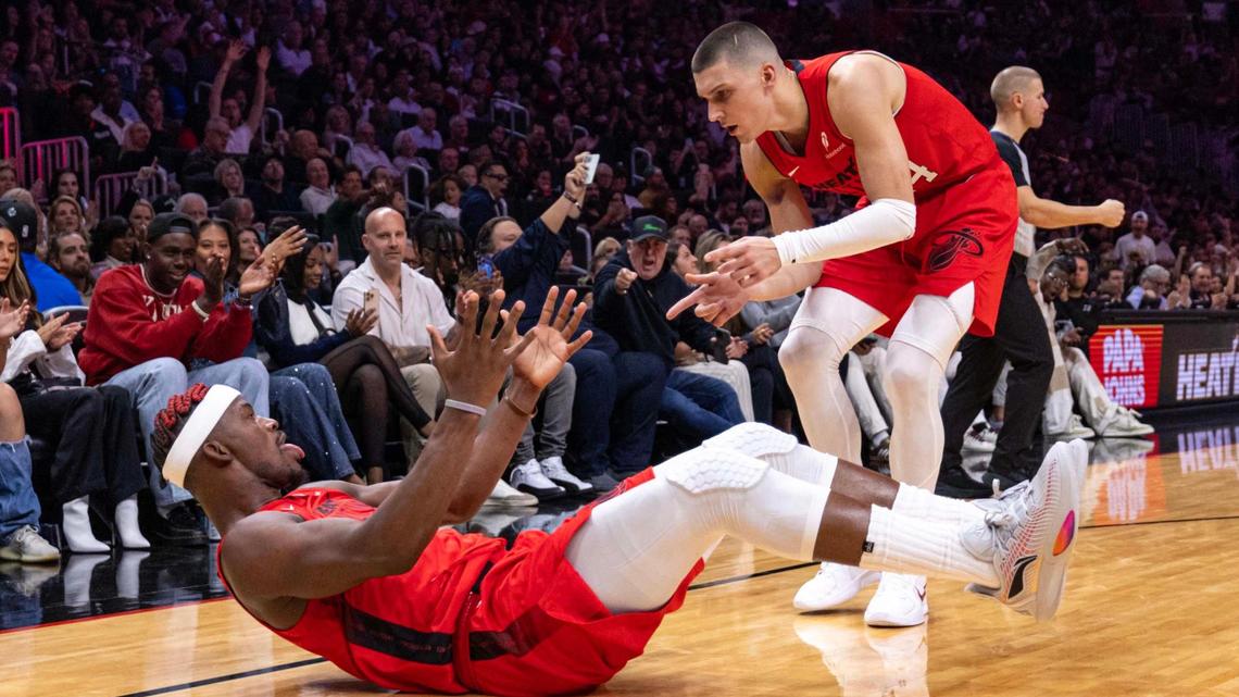 Miami Heat guard Tyler Herro (14) reacts with teammate Jimmy Butler (22) after Butler scored on an and one during the first half of an NBA game at Kaseya Center on Nov. 24, 2024, in Miami.