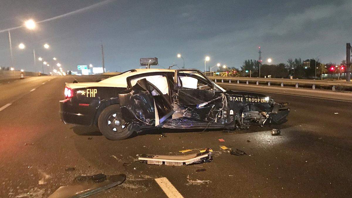 The northbound lanes of the Palmetto Expressway are shut down at Northwest 58th Avenue after a trooper patrol vehicle rolled over early Monday.