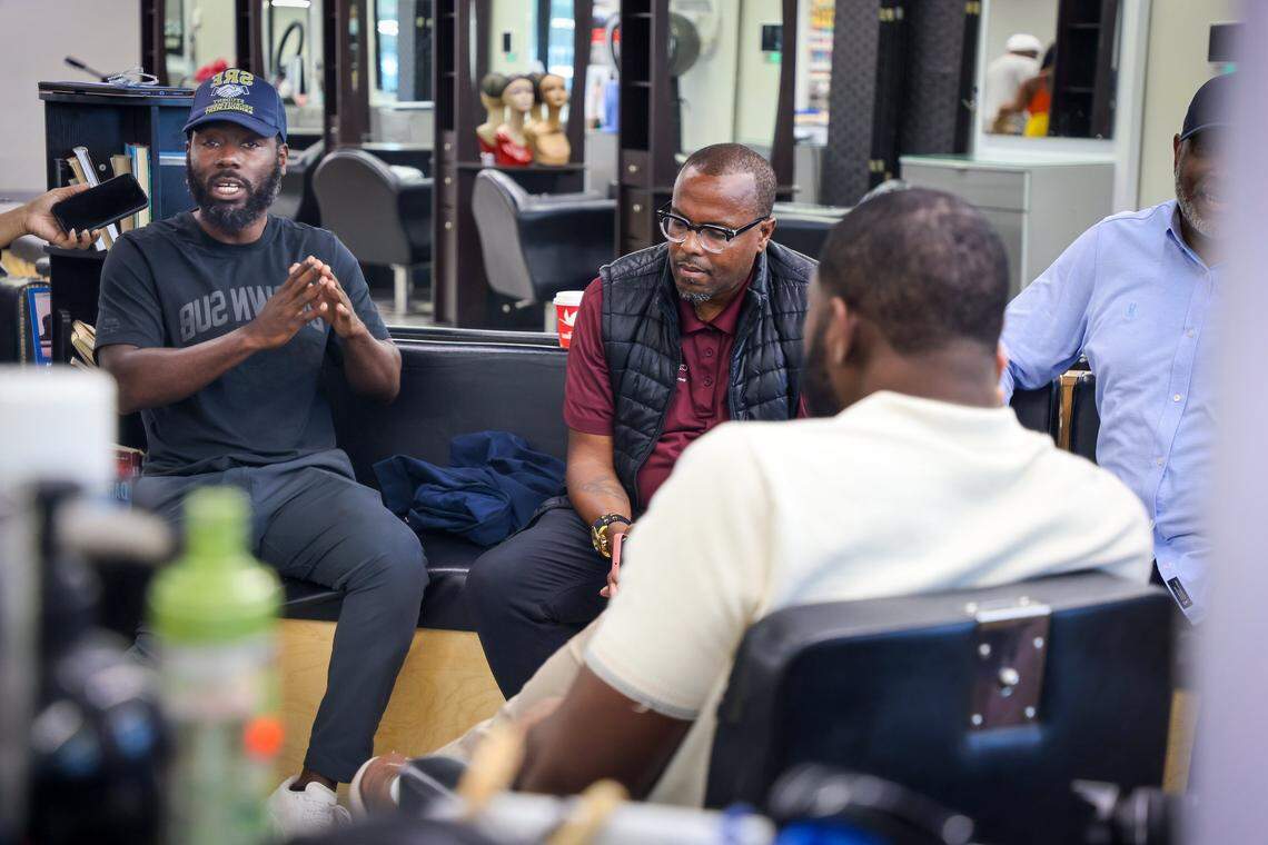 Ashley Toussaint, 45, left, community activist and educator, shares his thoughts as Lionel LightBourne, 53, a community advocate, Jefferson Noel, 31, and Ruban Roberts, 57, listen during a gathering of Black men at Topcuttaz in Miami Gardens. Six Black men - educators, community advocates, activists, and entrepreneurs gathered at the Topcuttaz barbershop to talk shop about the conditions of Black people in South Florida, a year after the election, and the impact of the first nine months of Trump’s administration.