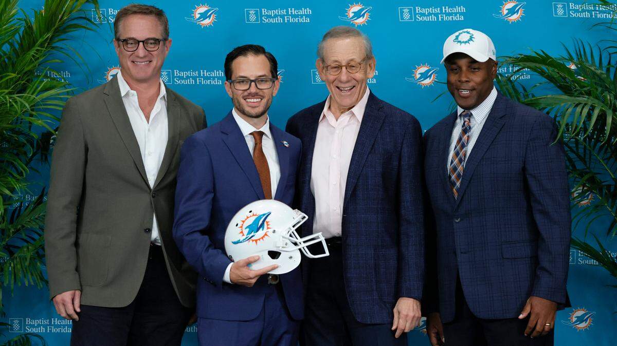 New Miami Dolphins head coach Mike McDaniel poses for the picture alongside Dolphins Vice Chairman, President and Chief Executive Officer Tom Garfinkel, Dolphins owner Stephen M. Ross and Dolphins general manager Chris Grier during his introductory press conference at Baptist Health Training Complex in Hard Rock Stadium on Thursday, February 10, 2022 in Miami Gardens, Florida.