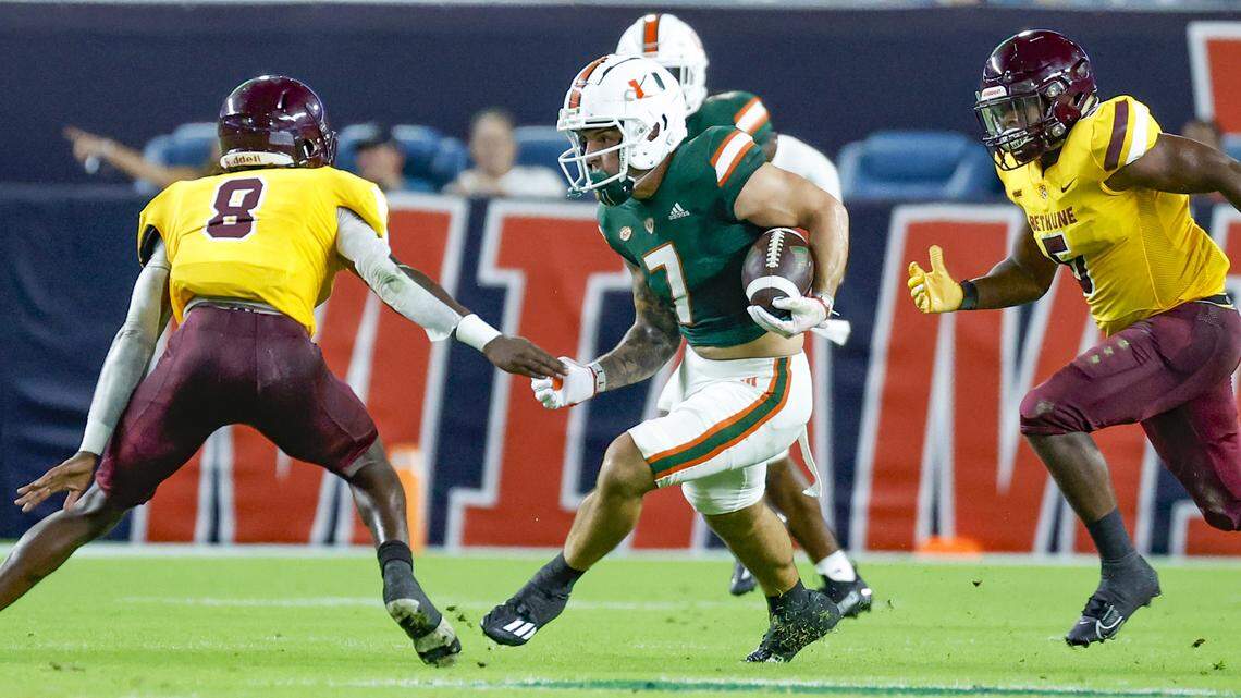 Miami Hurricanes wide receiver Xavier Restrepo (7) on a pass reception as Bethune Cookman Wildcats safety Johnny Harris III (8) attempts to make the stop in the first quarter at Hard Rock Stadium in Miami Gardens, Florida on Thursday, September 14, 2023.