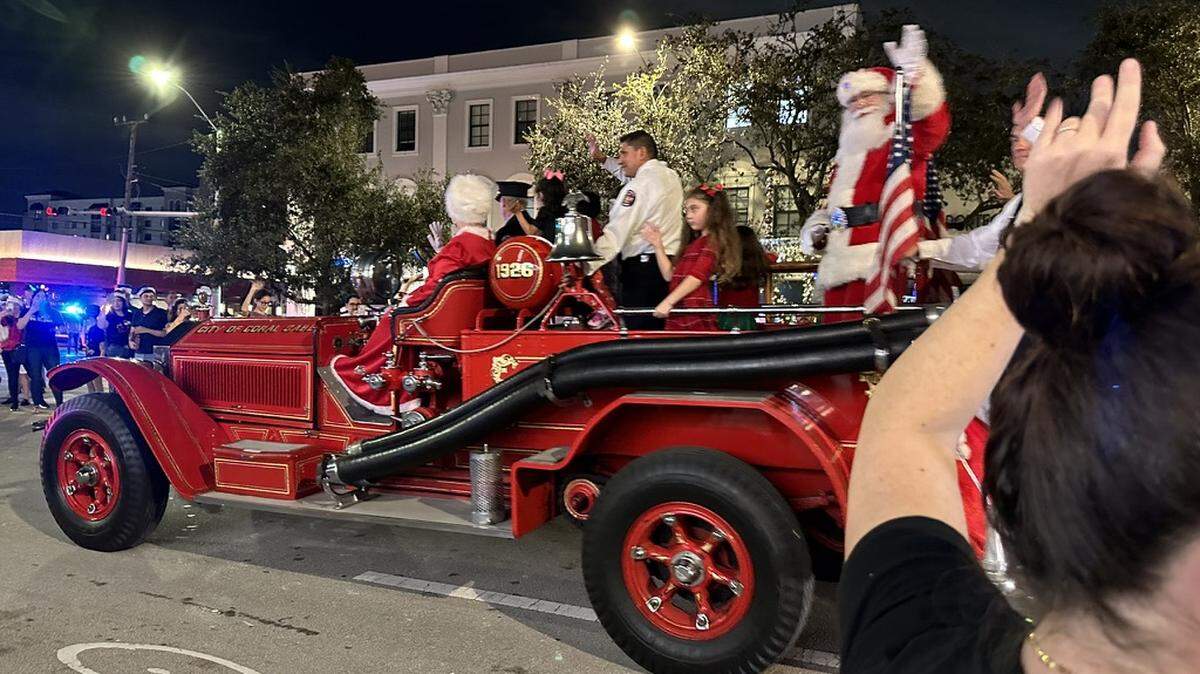 Santa Claus closes the 75th Annual Junior Orange Bowl Parade with waves to and from the crowd lining Miracle Miles in Coral Gables on Dec. 10, 2023.