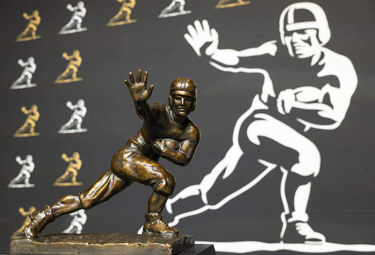 The Heisman Trophy is on display for guests at the Playoff Fan Central at the Miami Beach Convention Center on Friday, Jan. 16, 2025, in Miami Beach, Fla. Fans can visit the event ahead of the College Football Playoff National Championship Game between the Miami Hurricanes and the Indiana Hoosiers and enjoy a variety of family-friendly interactive experiences.
