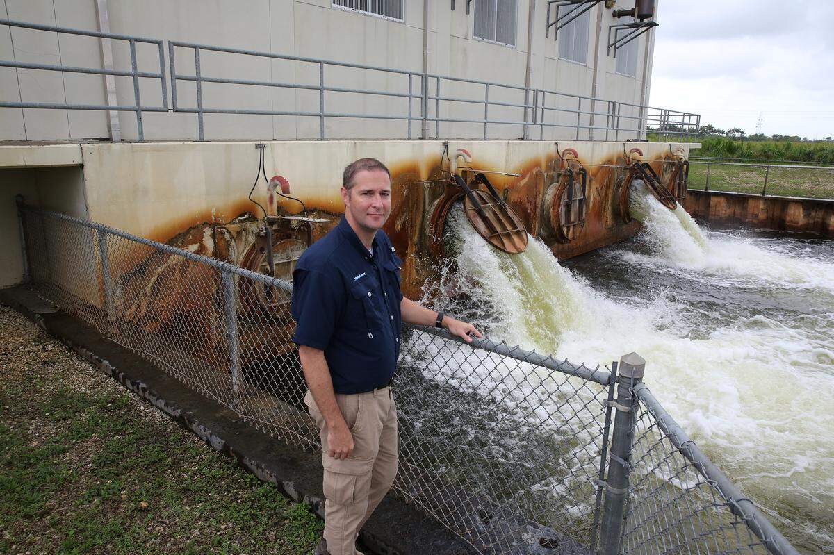 South Florida Water Management District chief engineer John Mitnik stands near a pump station south of the Tamiami Trail that drains water from the Las Palmas neighborhood, a rural area first settled in the 1960s beyond the L-31 levee intended to protect suburbs from Everglades flooding. Residents refused to move and battled government agencies for 15 years before finally settling on a compromise that preserved about two-thirds of the area behind a $4 million canal and levee. Photo by Emily Michot