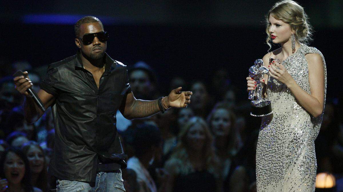 FILE - In this Sept. 13, 2009 file photo, singer Kanye West takes the microphone from singer Taylor Swift as she accepts the “Best Female Video” award during the MTV Video Music Awards in New York.