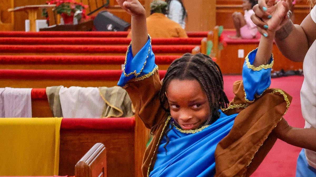 Raniya Benjamin, 8, tries on her costume for the Christmas play at Macedonia Missionary Baptist Church. Miami’s first Black church, Macedonia Missionary is about to undergo an expansion in order to facilitate more programming to help the local children. 