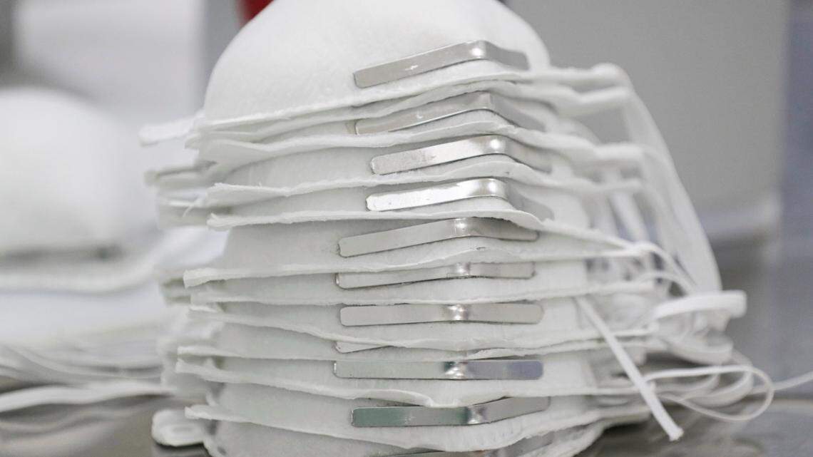 Face masks are stacked before getting technical information printed on them at a new factory in Mexico City, Thursday, May 21, 2020.