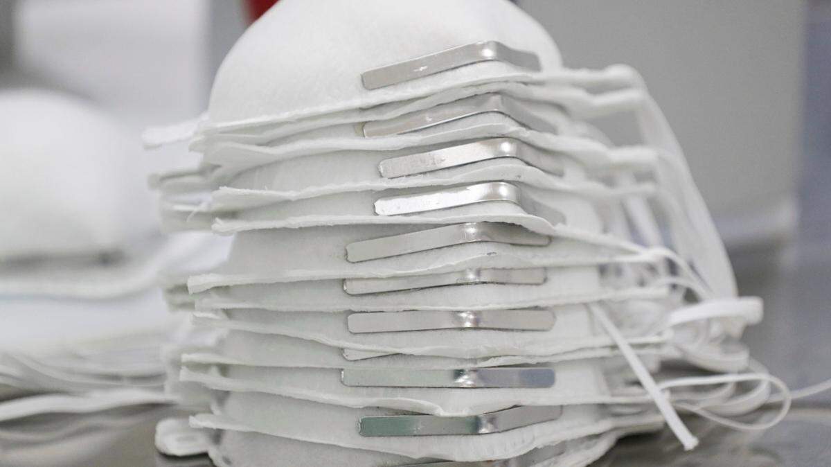 Face masks are stacked before getting technical information printed on them at a new factory in Mexico City, Thursday, May 21, 2020.