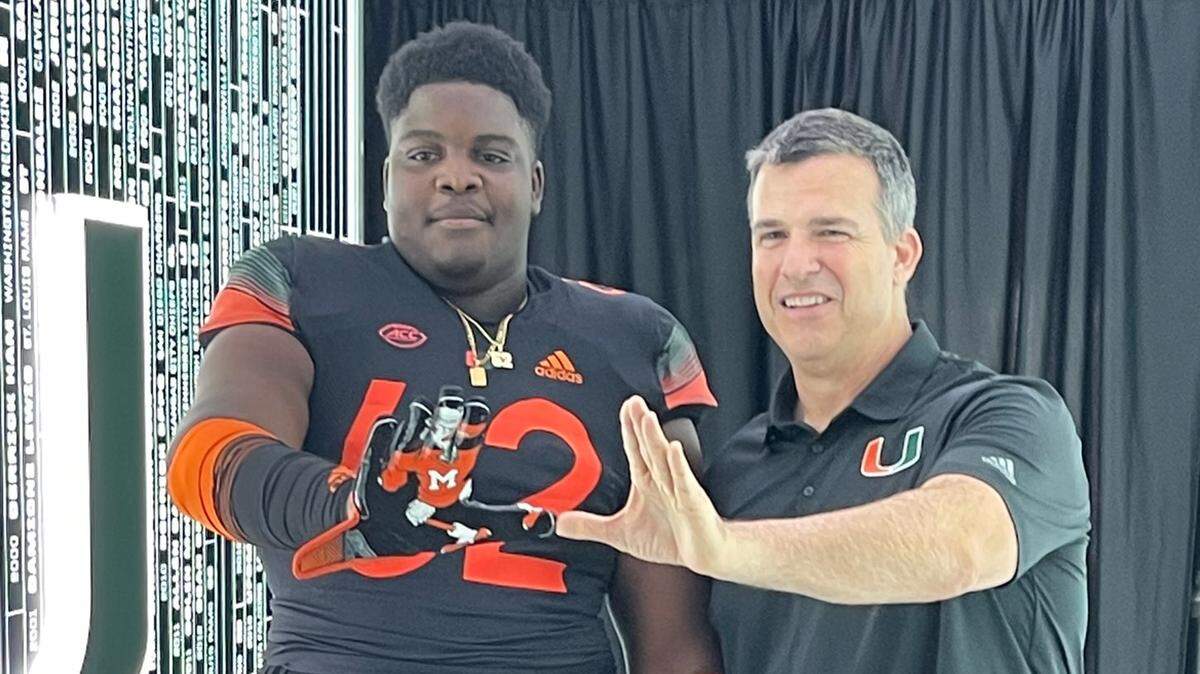 Tommy Kinsler (left) poses for a photo with coach Mario Cristobal during an official visit with the Miami Hurricanes in June of 2022.