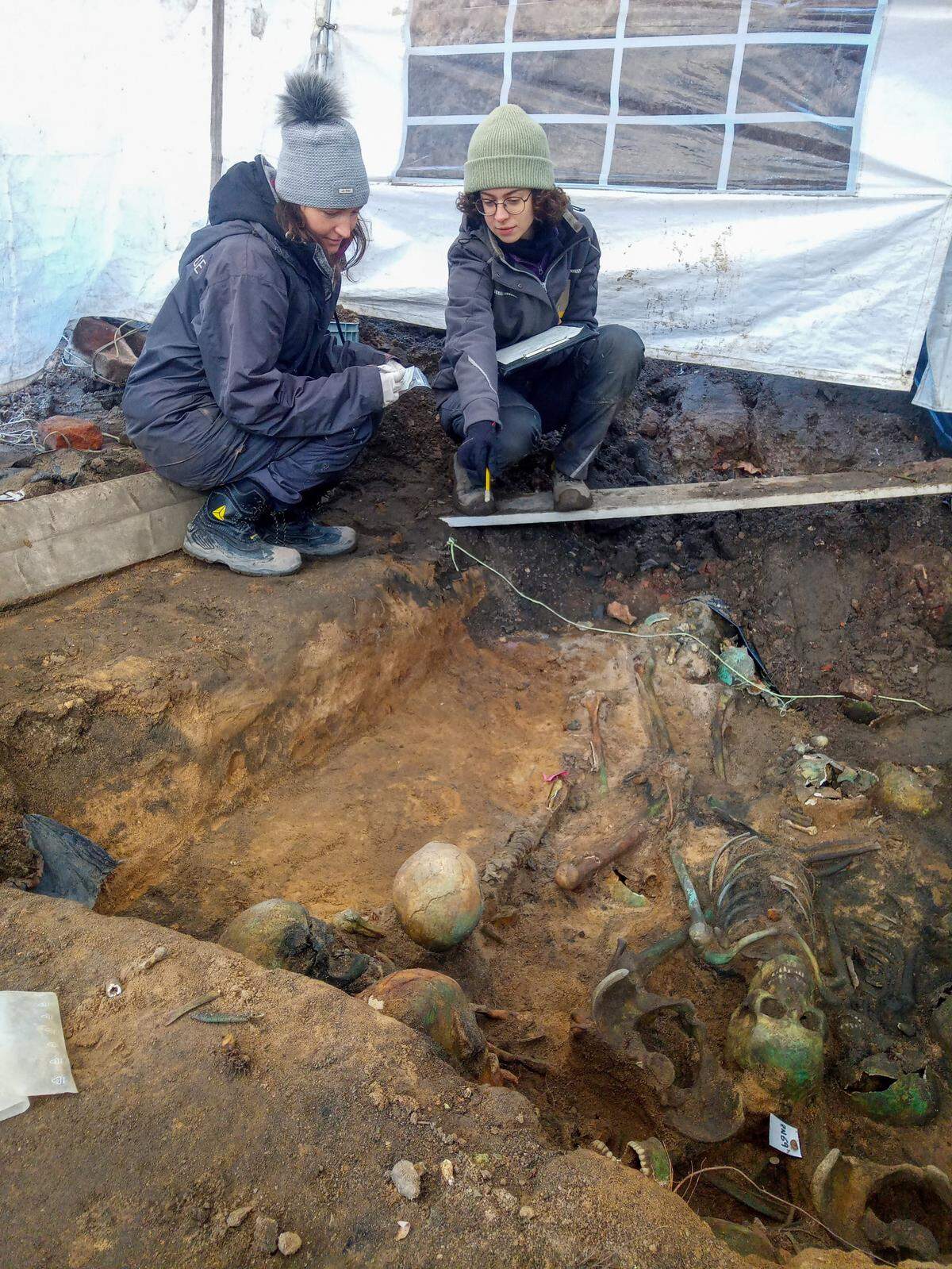 The remains were turned green by metal factories built on top of the burials, researchers said.