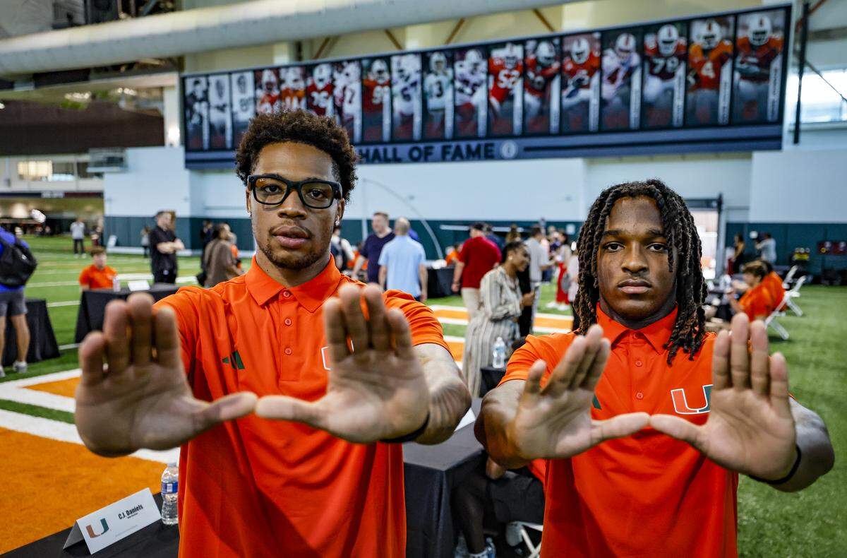 Miami Hurricanes wide receivers C.J. Daniels and Malachi Toney, left to right, flash the U after speaking to reporters during Media Day at the Carol Soffer Indoor Practice Facility in Coral Gables, Florida, on Wednesday, July 30, 2025.