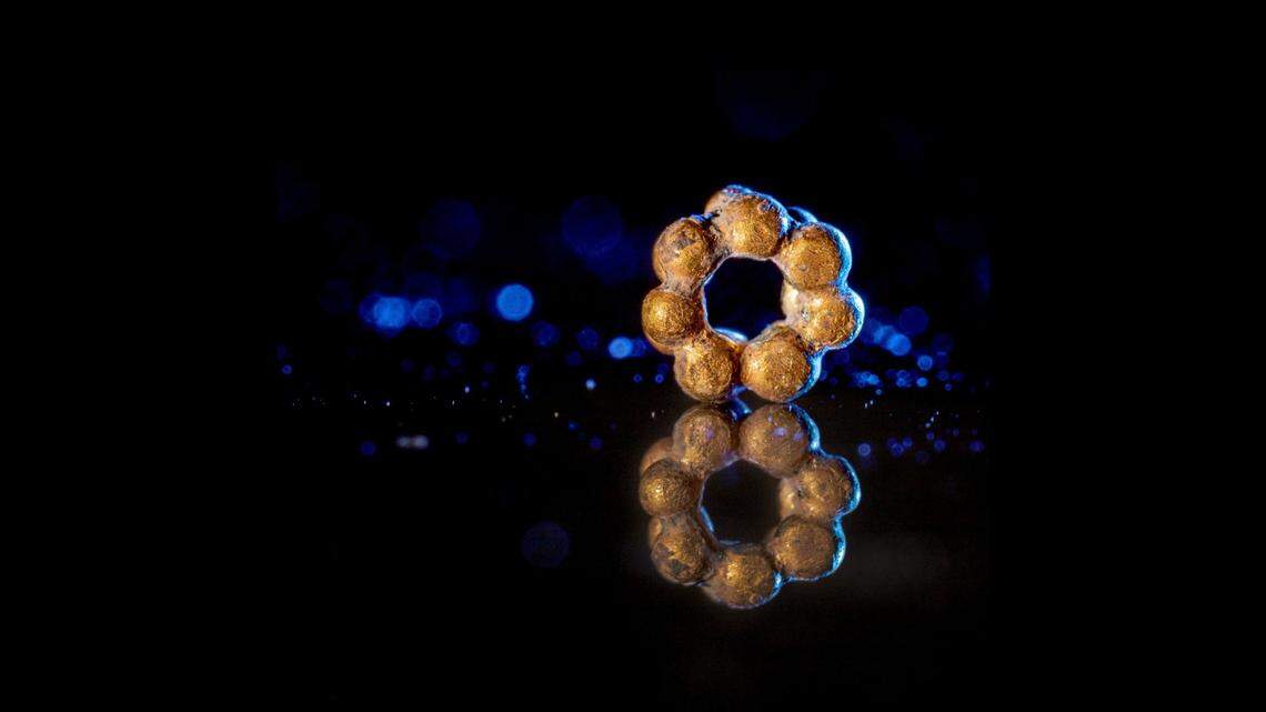 A volunteer was sifting through dirt from a Roman structure when she found a shiny gold bead, photos show and Israeli archaeologists said.