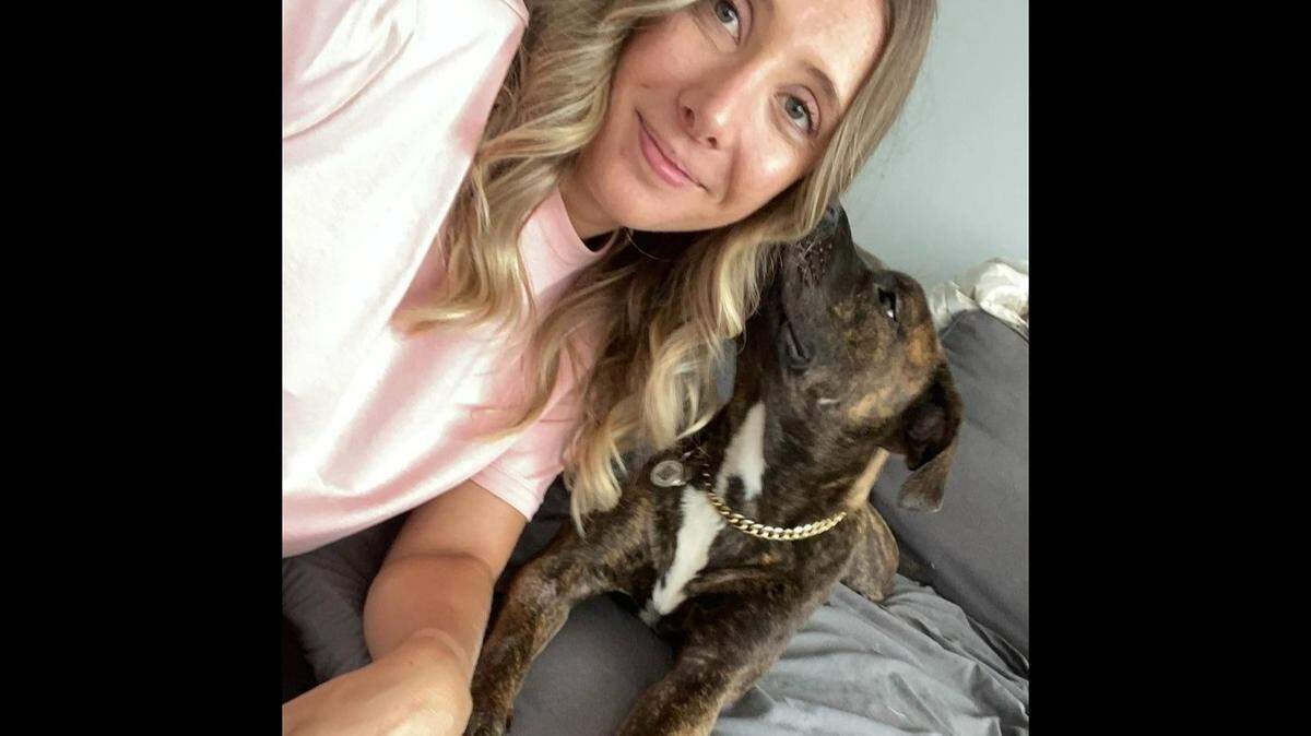 Amandine Lorenzo smiles next to her thee-year-old dog named Tuna.