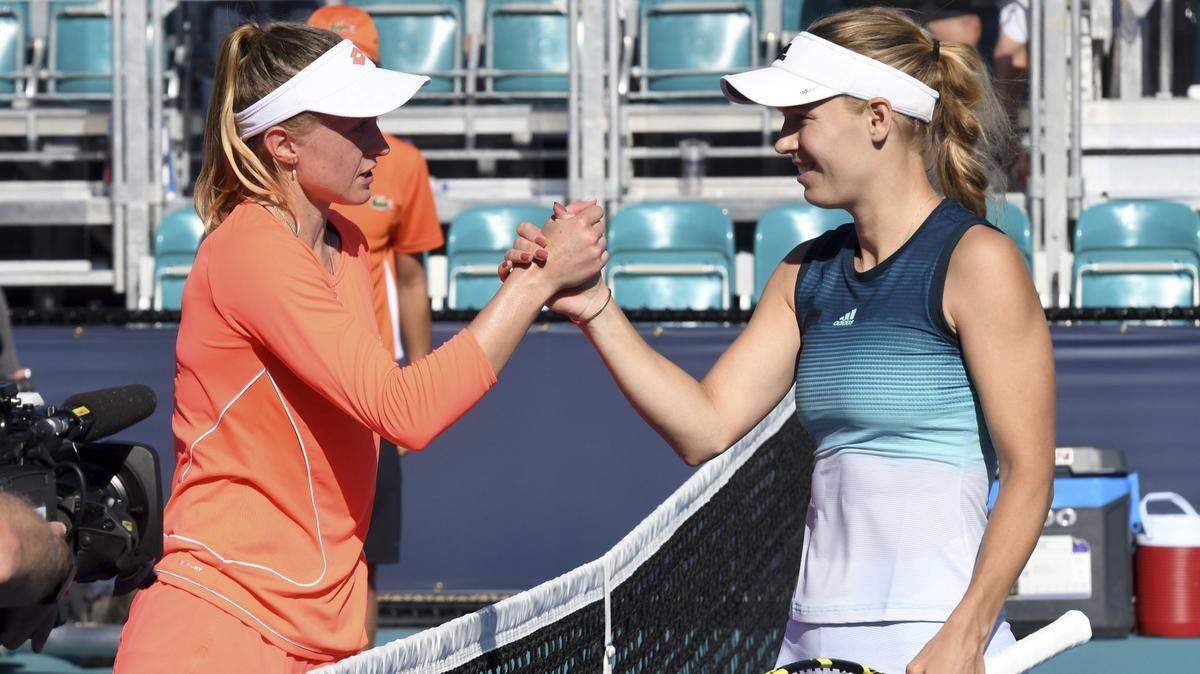 Caroline Wozniacki, right, of Denmark, shakes hands after defeating Aliaksandra Sasnovich, left, of Belarus, during the Miami Open tennis tournament, Friday, March 22, 2019, in Miami Gardens, Fla.