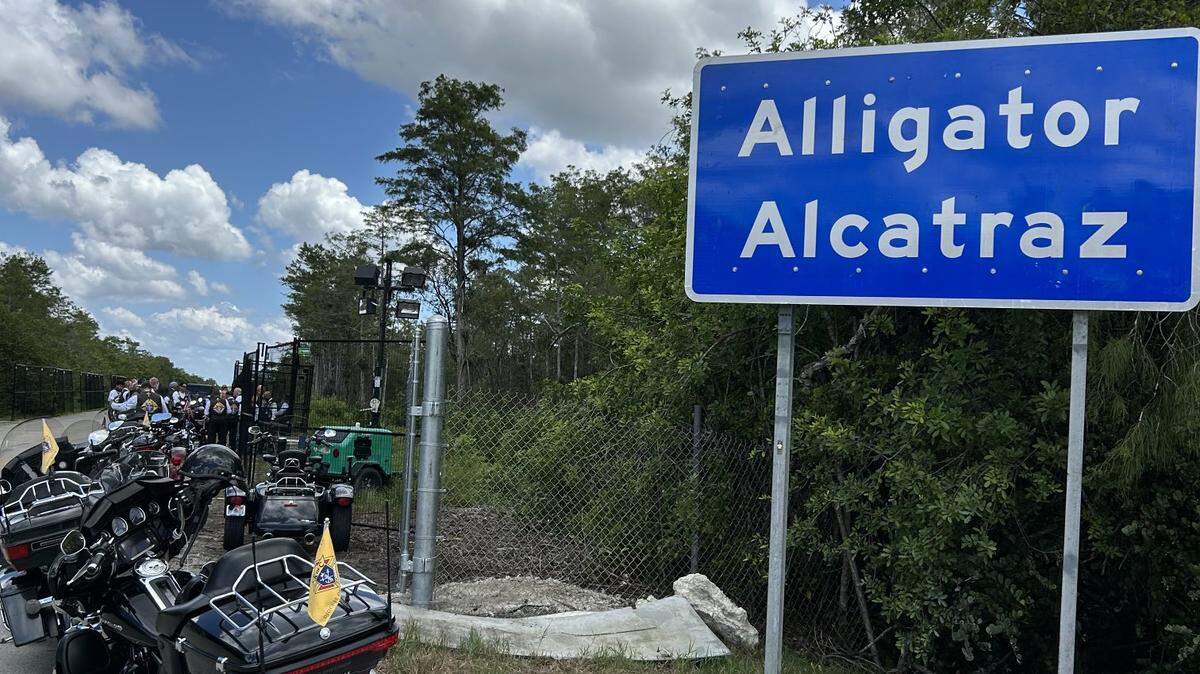 Motorcycles belonging to Archbishop Thomas Wenski and 25 other Catholics who belong to the Archdiocese of Miami’s Knights on Bikes ministry sit outside the ‘Alligator Alcatraz’ sign in the Everglades. Wenski recently denounced the migrant detention center, saying it was “unbecoming of public officials.”