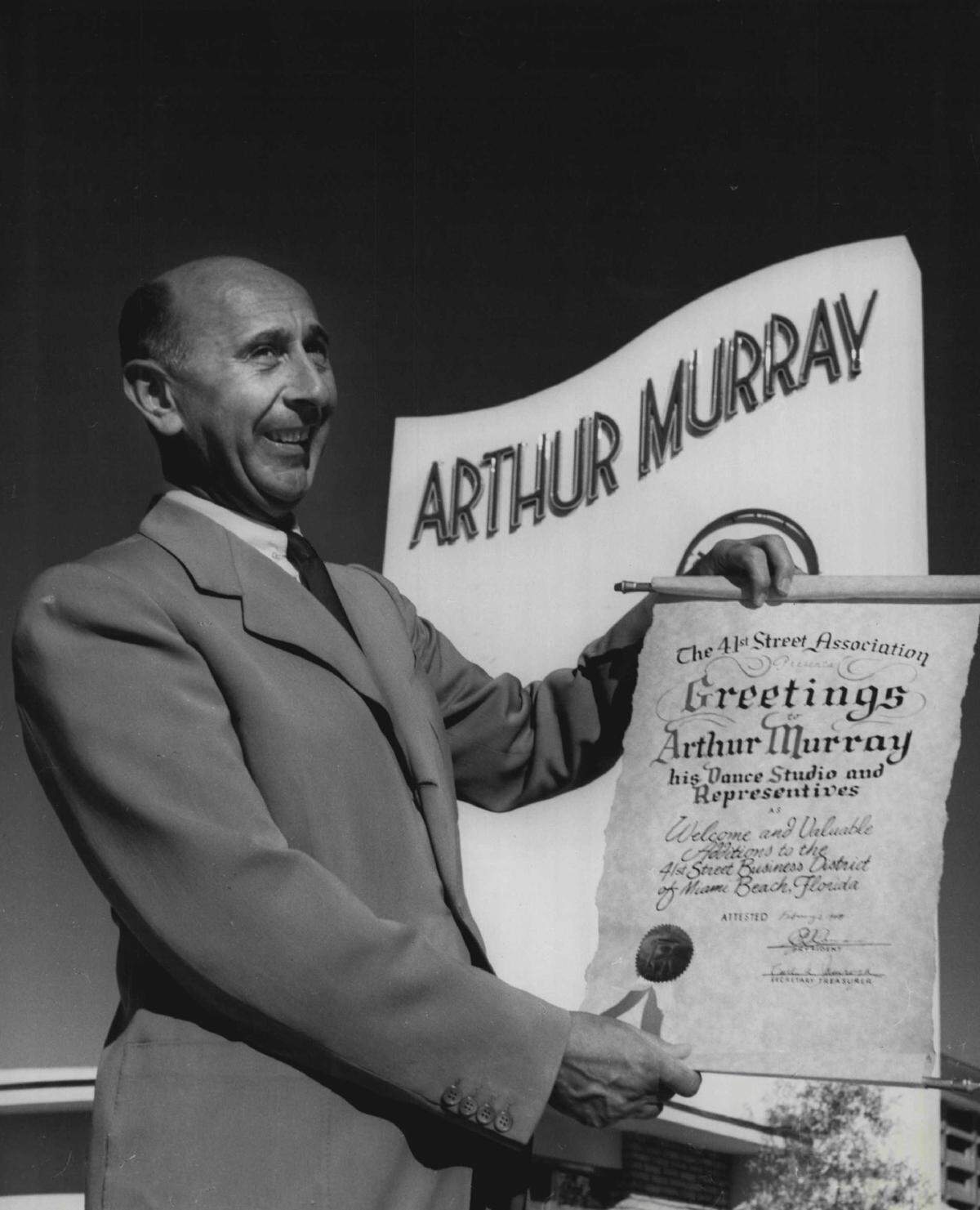 Arthur Murray displays the scroll presented to him as a new member of the 41st street association. Murray had just opened his $200,000 dance studio at 767 41st St. in Miami Beach, the 167th unit in the coast-to-coast chain.