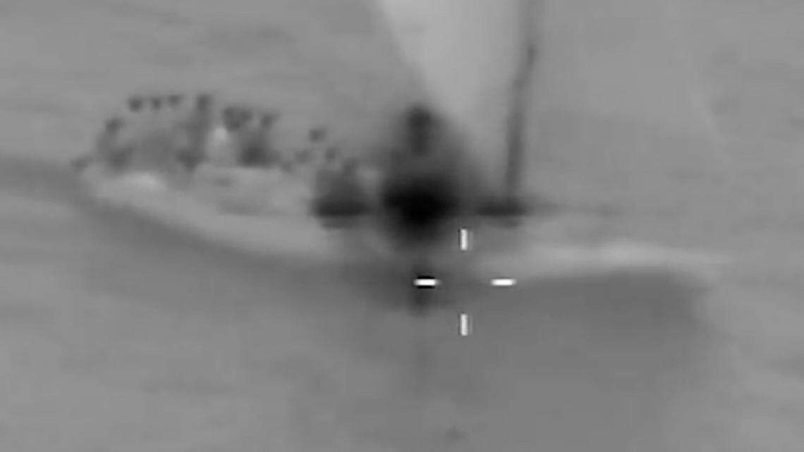 Grainy footage taken from a U.S. Coast Guard aircraft shows an overloaded sailboat packed with people from Haiti off the coast of Anguilla Cay Friday, March 4, 2022.