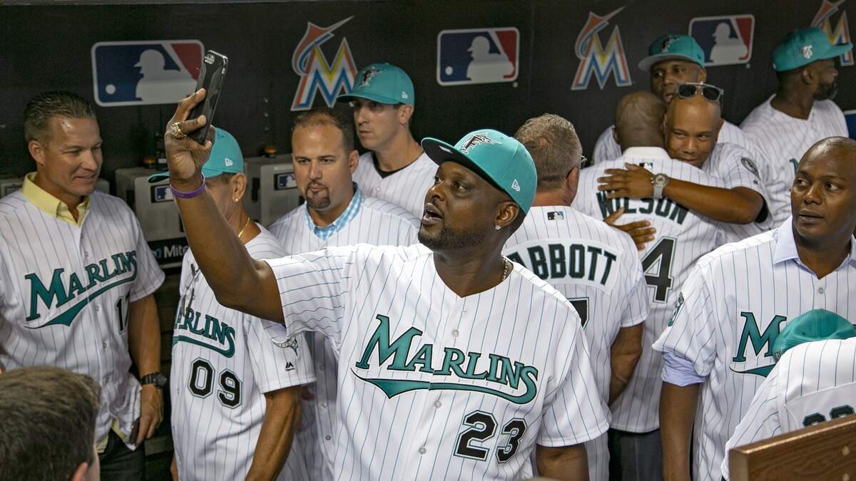 Charlie Johnson takes a selfie with former Marlins players in the dugout as the Miami Marlins prepare to host the San Diego Padres at Marlins Park on Saturday, June 9, 2018. 