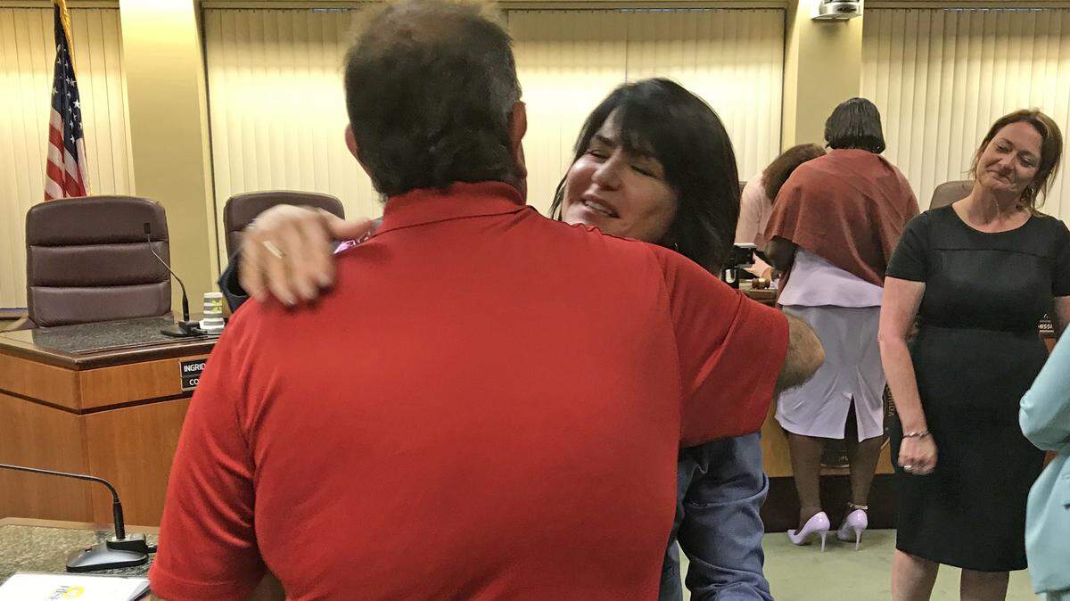 Ana M. Garcia embraces resident Terrance Camenzuli after she was ousted as city manager of North Miami Beach during a special City Commission meeting on Tuesday night, July 10, 2018.