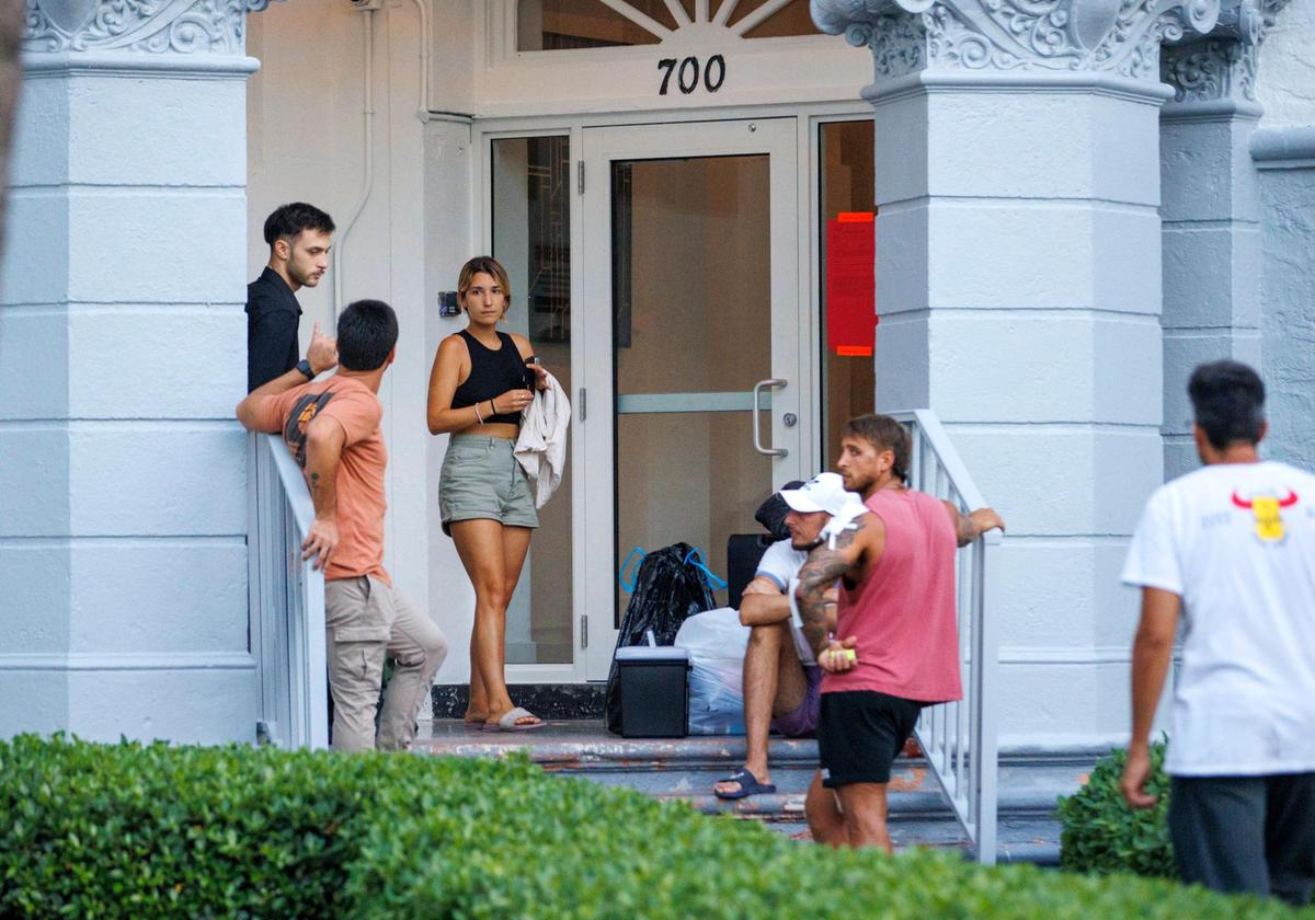 Miami Beach resident Laura Lorenzo waits for an Uber with friends after she was forced to leave her apartment building at 700 Euclid Ave. The four-story, 54-unit building suffered a partial roof collapse and got an unsafe structure notice on Wednesday, June 15, 2022.