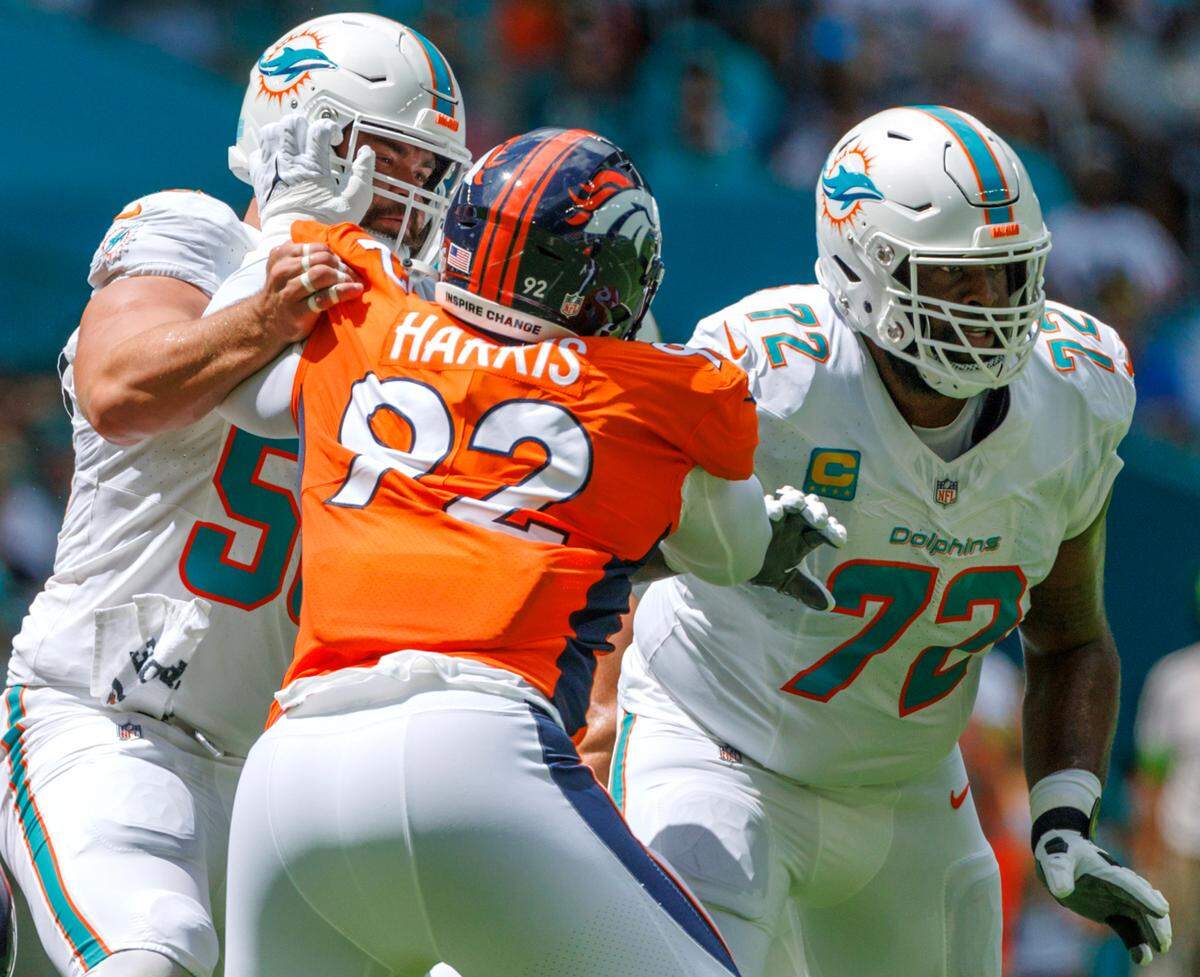 Miami Dolphins guard Connor Williams (58) and Dolphins offensive tackle Terron Armstead (72) block Denver Broncos defensive tackle Jonathan Harris (92) during first quarter of an NFL football game at Hard Rock Stadium on Sunday, Sept. 24, 2023 in Miami Gardens, Fl.