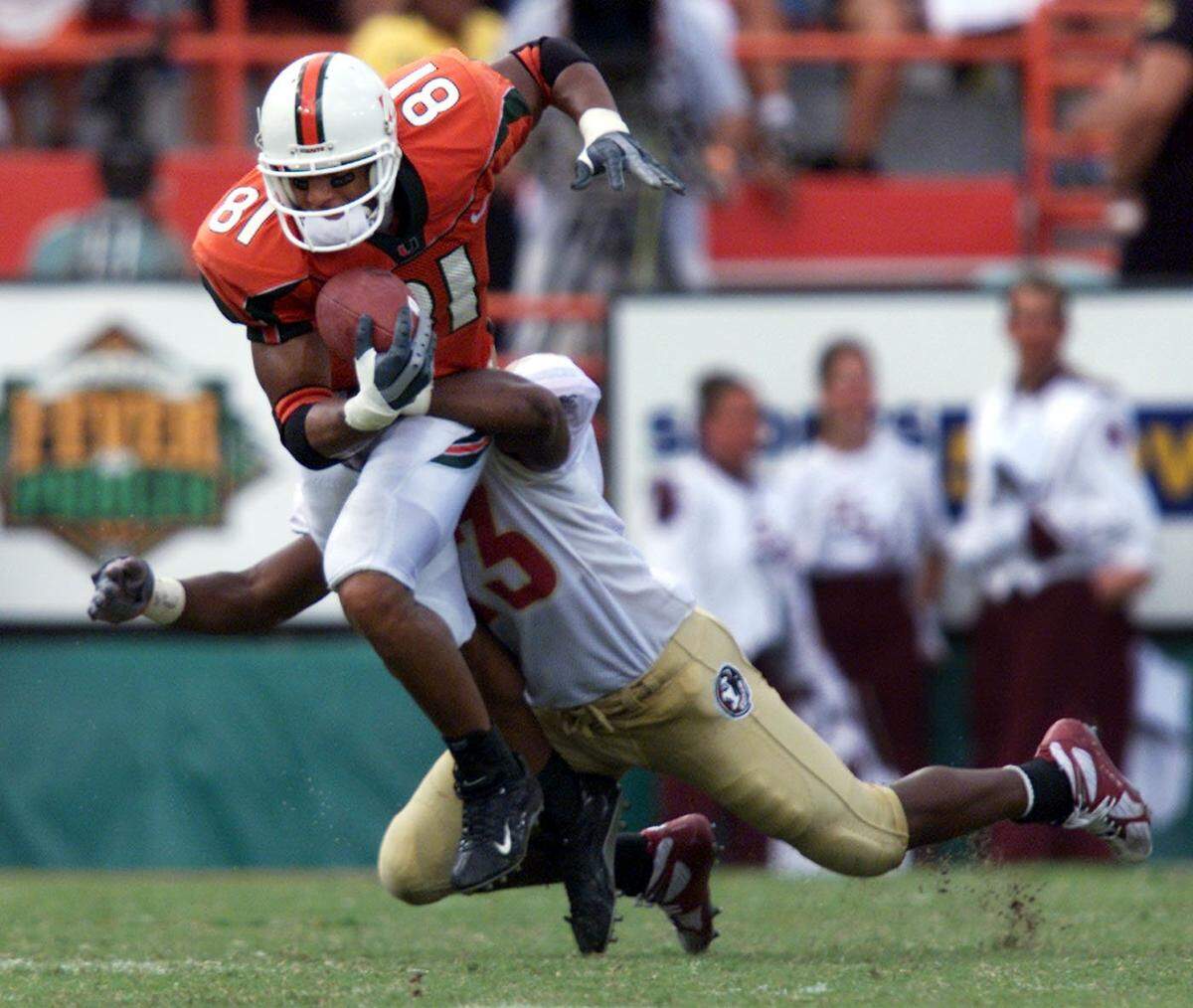 In 2002, UM's Kellen Winslow hauls in a pass over FSU's Jerome Carter during the Canes' 28-27 win at the Orange Bowl.
