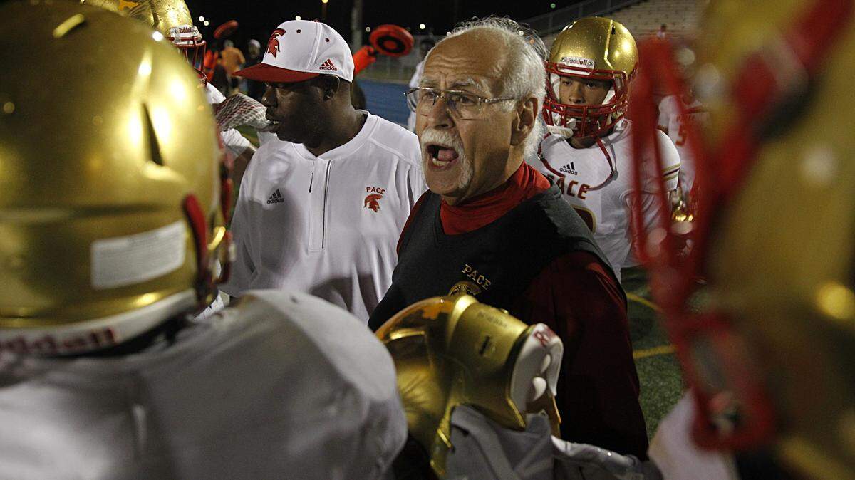 Pace’s head coach Joe Zaccheo talks to players in during a time out in the second quarter as the Monsignor Edward Pace High School takes on Miami Edison Senior High School at Traz Powell Stadium in North Miami on Saturday, October14, 2017.
