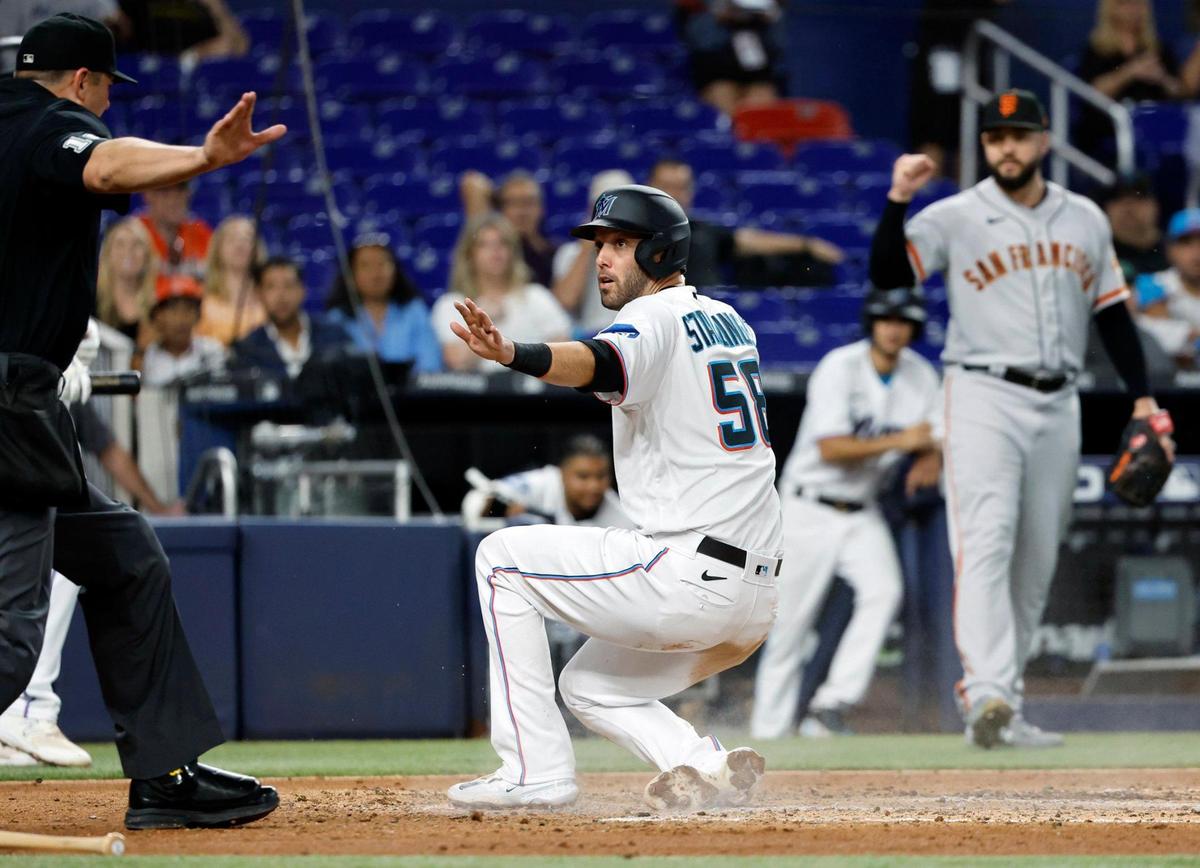 Miami Marlins catcher Jacob Stallings (58) scores at home plate as San Francisco Giants catcher Blake Sabol (2) unable to apply a tag in the third inning at LoanDepot Park in Miami, Fl on Tuesday, April 18, 2023.