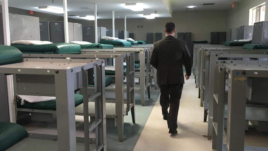 James McClelland, chief operating officer of Bridges International, walks through one of the now-empty dorms at Turning Point Bridge.