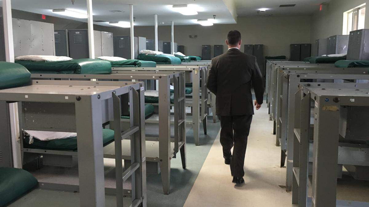 James McClelland, chief operating officer of Bridges International, walks through one of the now-empty dorms at Turning Point Bridge.