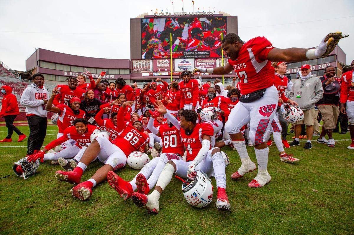 Cardinal Gibbons varsity football team celebrates in the middle of the field after defeating Jacksonville Bolles during the 4A State Championship at Doak Campbell Stadium in Tallahassee, Florida, on Thursday, December 17, 2020. The Chiefs were victorious over the Bulldogs 35-21.