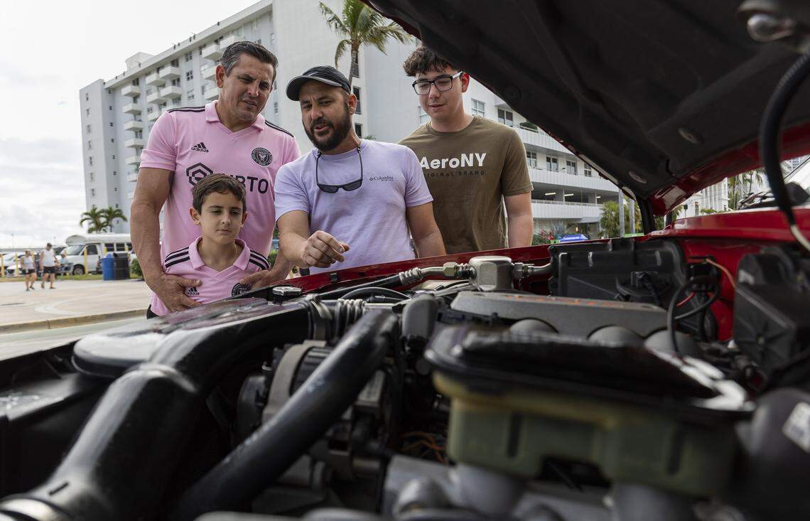 From left: A still image of Jorge Quilez, Richard Quilez, 8, Narby Luna and Jose Rodriguez inspecting the motor of a 1993 Chevrolet Blazer S-10 Blazer Tahoe LT on display at the Classic Car Show during Art Deco Weekend at Ocean Drive on Saturday, Jan. 10, 2026, in Miami Beach, Fla.